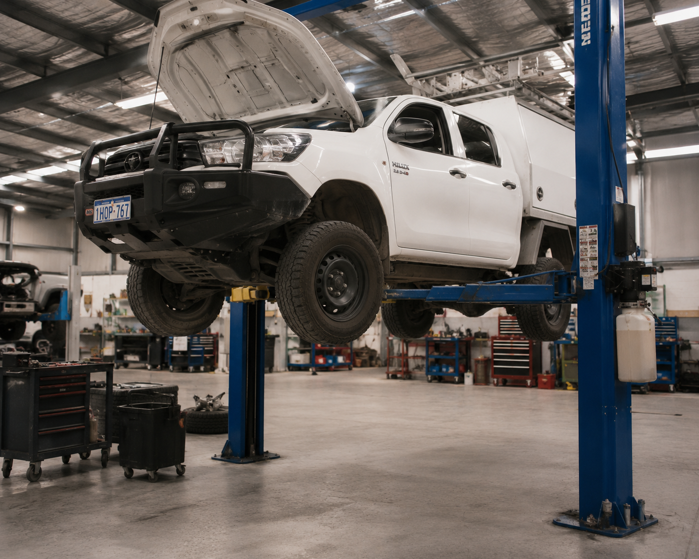 Industrial workshop with lifted utility truck